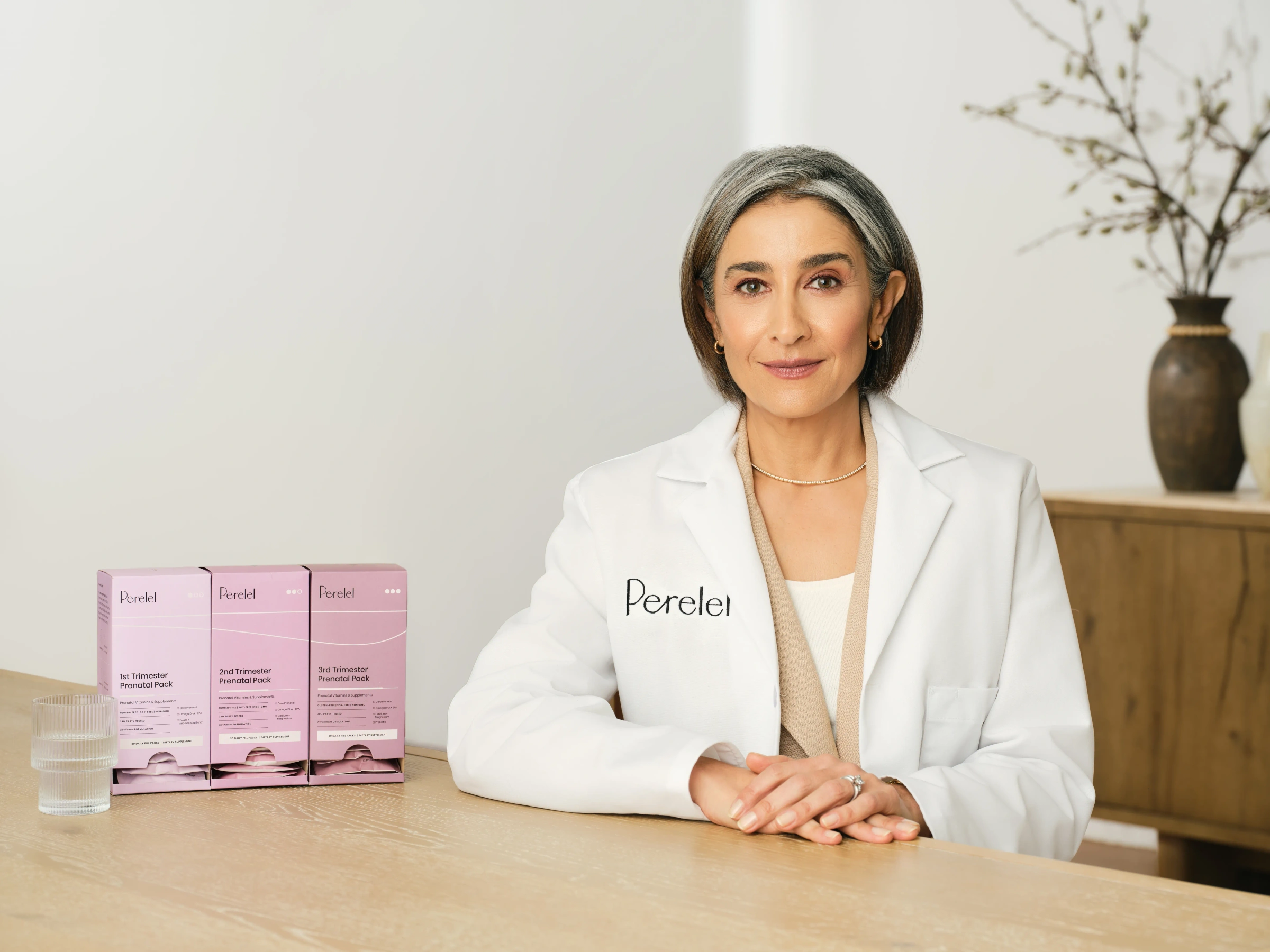 Perelel Panel doctor at a table with three vitamin pack boxes